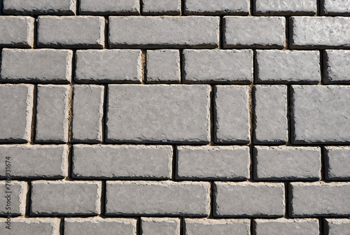 Background paving slabs. Cement-brick floor. Promenade, view from top. Abstract texture - gray paving tiles in form of squares. Gray square sidewalk. Seamless slanted textures. Space for text or logo