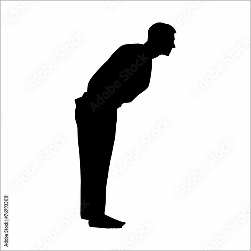 Silhouette of a man bowing his body, in honor of japanese culture, before competing in the martial art of karate