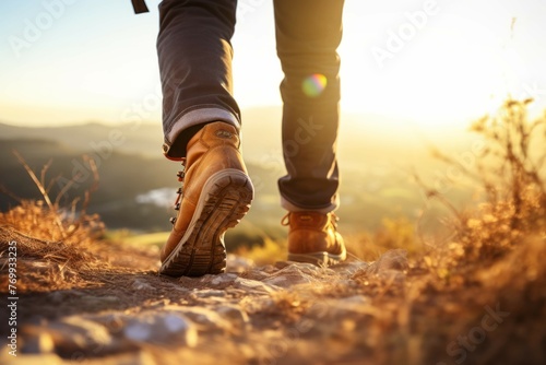 person hiking wearing hiking boots walking down the hill in the afternoon photo