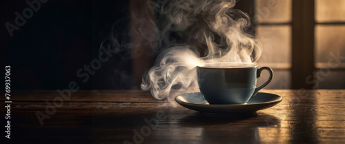 steaming cup of coffee or tea on vintage table photo