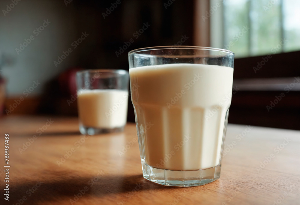 Glass of Milk on Table. A glass of milk sits on a wooden table.