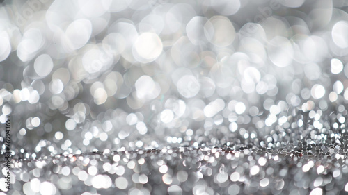 An abstract, defocused background in a shimmering silver, with sparkling platinum bokeh lights, evoking the glamorous sparkle of a star-studded gala.