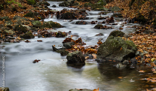 Water flowing from the river in the fall. Long exposure