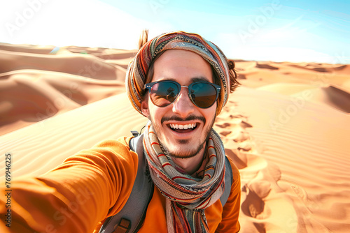 Joyful male Traveler Taking a Self-Portrait in the Desert Dunes