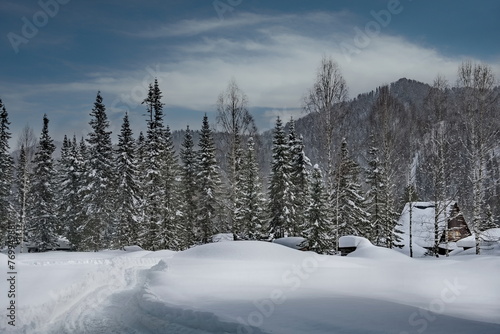 Russia. Kuznetsk Alatau. Winter view of the holiday village of Borisovka among the snow-covered impassable taiga on the banks of the Tom River. photo