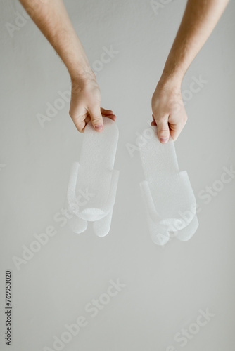 male hands holding disposable slippers on a white background photo