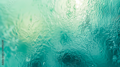 Frosted glass with a structure in light shades of green and blue with a delicate texture and a blurred appearance. photo