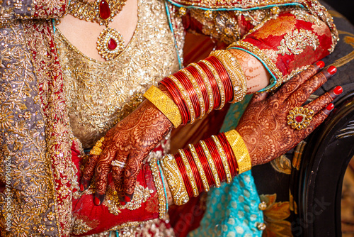 Beautiful detail of Indian bridal jewelry and sari © Liesl