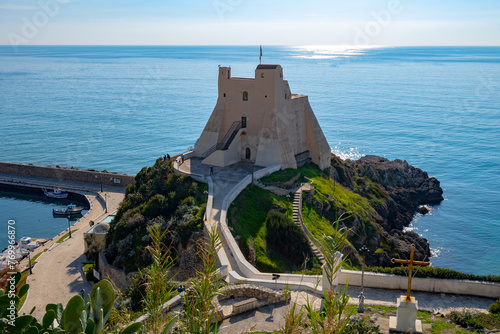 View on white harbour tower from hilly medieval small touristic coastal town Sperlonga and sea shore, Latina, Italy