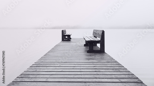 Fotografie Two benches opposite each other on the pier and fog on the lake.
