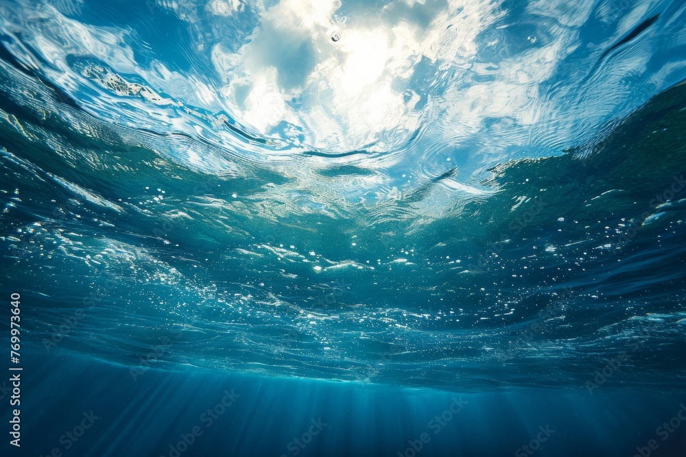 Underwater View of the Ocean, A hydrosphere viewed from the ocean floor, looking up towards the water surface and the sky, AI Generated