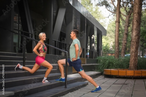 Happy young couple training cardio workout in the park