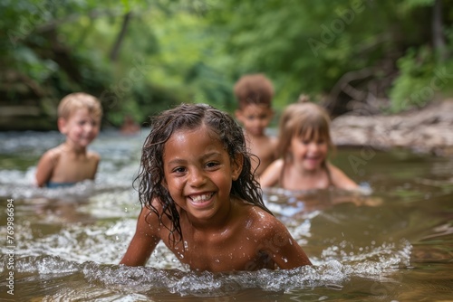 Group of children wading and playing in river, showing expressions and activities © Ilia Nesolenyi