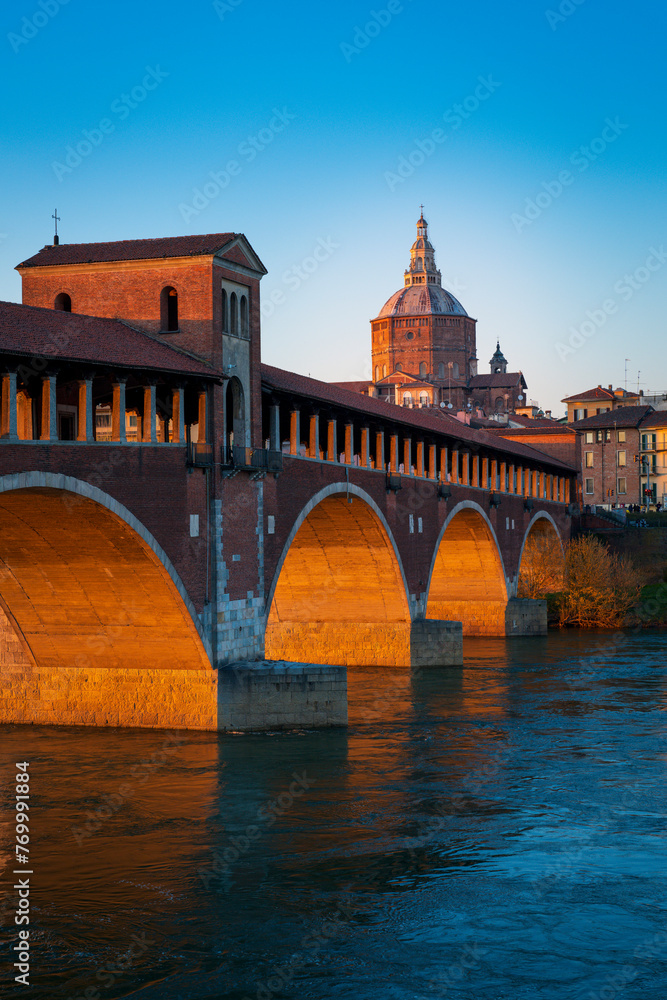 Panorama of covered bridge and Pavia cathedral at wonderful sunset