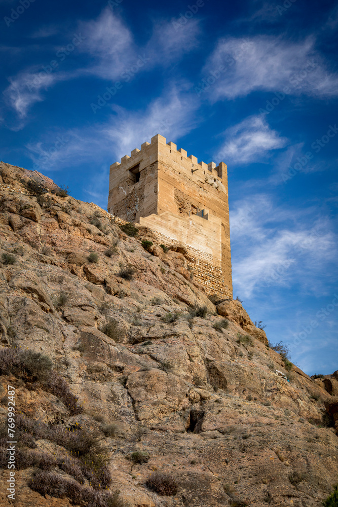 Crenellated Tower of Homenaje of the medieval castle of Alhama de Murcia, Region of Murcia, Spain, on a high cliff