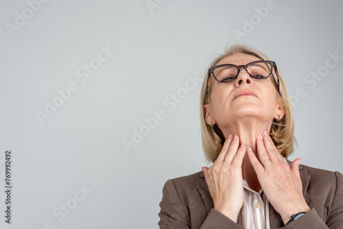 Woman thyroid gland control. Senior lady sweeping the laryngeal, laryngitis, goiter or Hypothyroidism. Disorder of the endocrine system. Hashimoto’s Thyroiditis, Lymphocytic Thyroiditis. photo