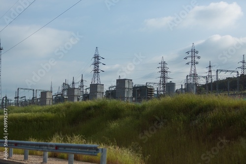 High voltage tower construction on landscape background