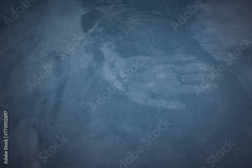 Mark of the hand on the blue velour textured surface. Palm silhouette. Concept of ghostly vision, phantom. handprint on fabric. photo