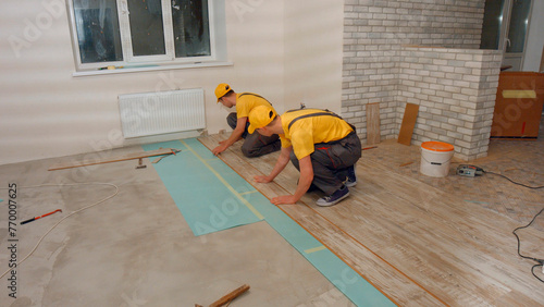 Laying parquet board in the apartment. Repair in the house. © DenisProduction.com