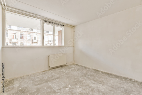 Empty room with large window and concrete floor
