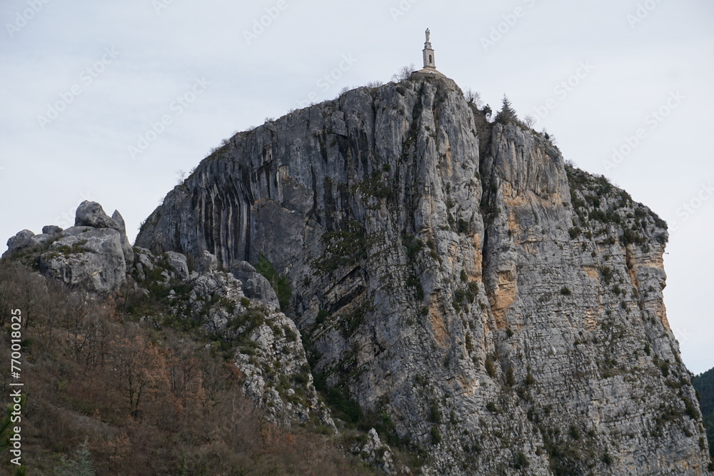 rocky cliff of Castellane, soutern France with the old stone church above