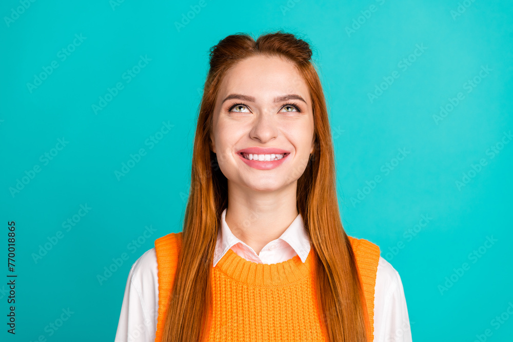 Fototapeta premium Photo portrait of pretty young girl look up empty space wear trendy orange knitwear outfit isolated on cyan color background