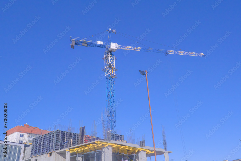 Construction tower crane on a construction site.