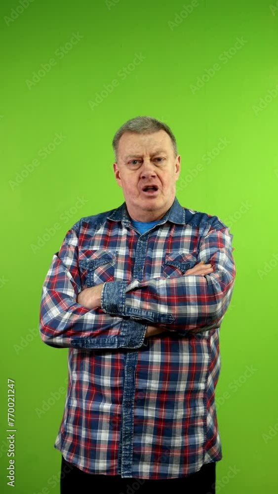 Senior man in casual clothing turns his head and says absolutely no. Senior man in casual clothing turns his head and says absolutely no.