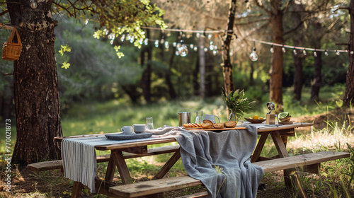 Camping. There is a large amount of food and dishes on the table photo