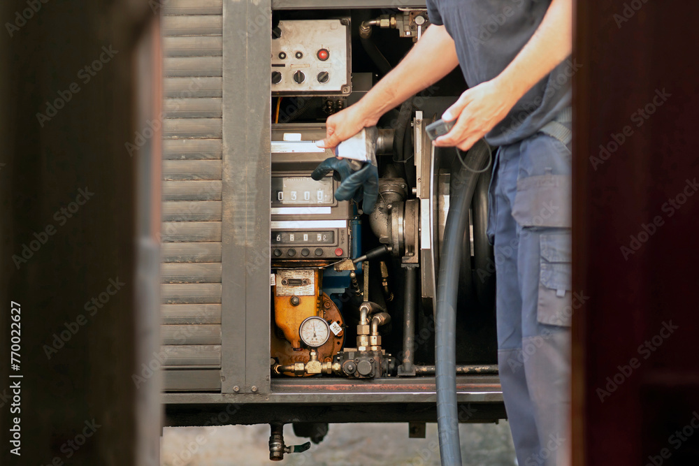 company truck parked front a house and delivery worker with hose to supply fuel for heating oil for boilers company truck parked front a house and delivery worker with hose to supply fuel for heating oil for boilers