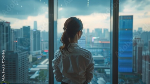 Woman Standing by City Window