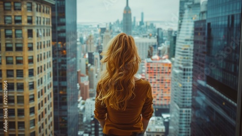 Woman Looking Out Window at Night Cityscape