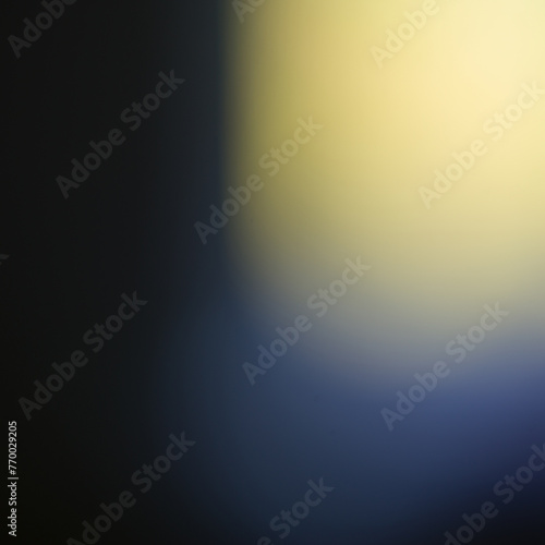 One light-yellow spot in the blue frame, an abstract blurry background.