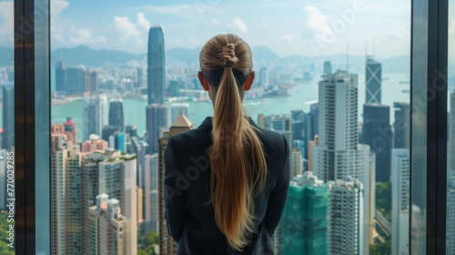 Woman Looking Out Window at Night Cityscape