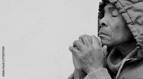 man praying to god with hands together Caribbean man praying with grey background stock image stock photo 