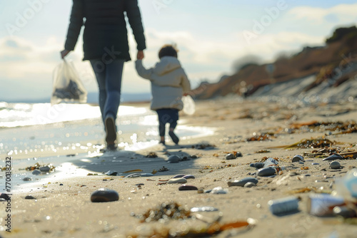 A woman and a child are walking on a beach