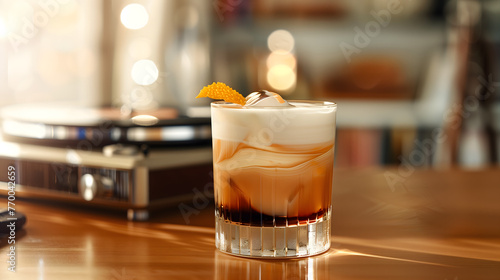 A visually striking White Russian cocktail with a perfect blend of cream and coffee, garnished with a zest of orange on a polished wooden surface.
 photo