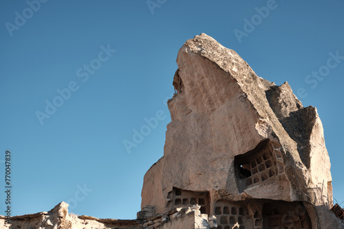 Cave dwelling carved in limestone rock formations. Fairy chimney at Cappadocia. Rock hoodoo in Goreme village, Nevsehir province, Turkiye. UNESCO World Heritage site