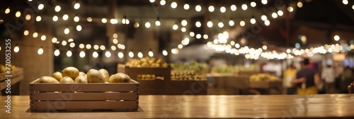 Wooden crate of potatoes on wooden counter at blur background with lights. Fresh vegetables in farmers market or supermarket, wide format close up with copy space for text, horizontal format