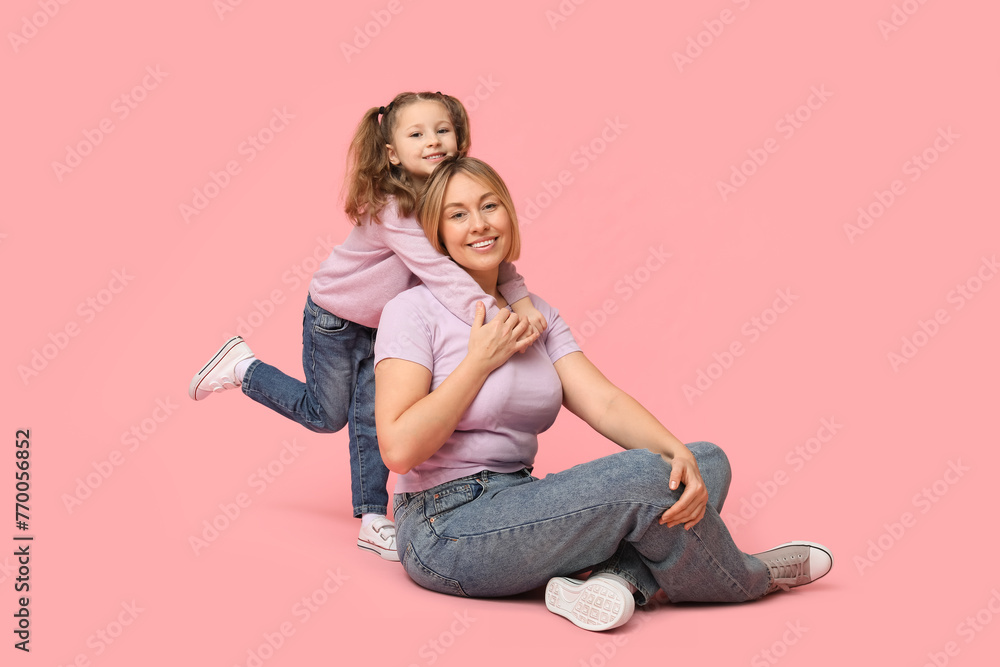 Mother playing with her daughter on pink background. Mother's Day Mother playing with her daughter on pink background. Mother's Day