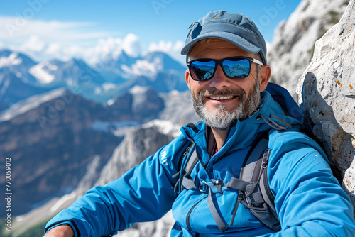 Bearded Man in Sunglasses Standing on Mountain Top
