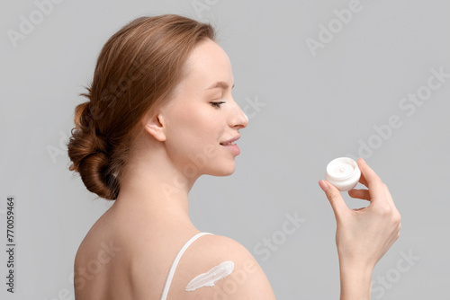 Young woman with jar of cre...