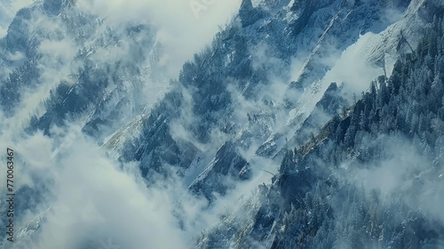  A clear photo of a snowy mountain range from above, showing the cloud-covered peaks and a bird's perspective on the summit