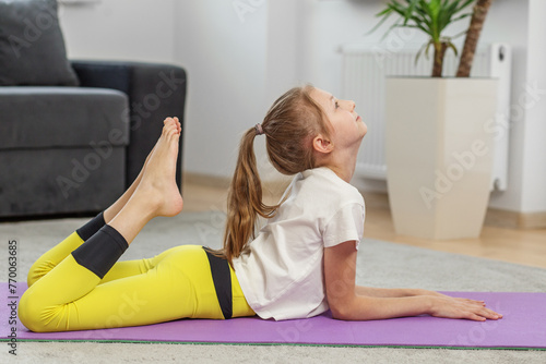 Photography Child Demonstrating Advanced Yoga Stretch at Home