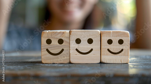 Smiling emoticon is drawn on the wooden cubes, symbolizing the joy of working in team.