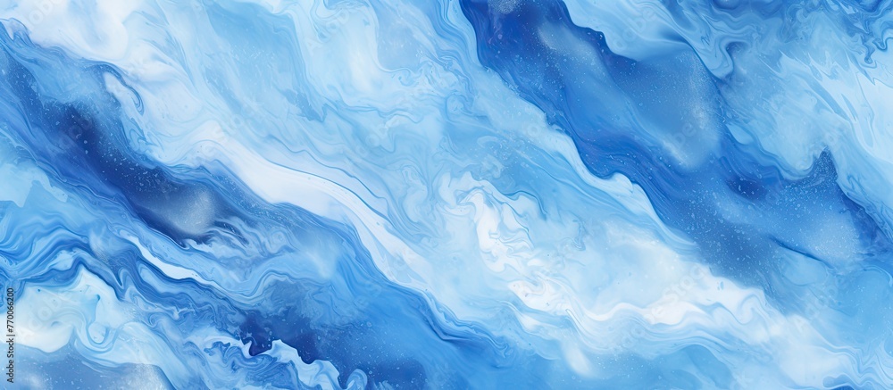 A close up of a blue and white marble texture resembling a swirling cloud formation in the sky. The electric blue pattern resembles a wind wave in a natural landscape