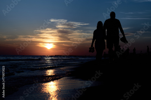 Silhouettes of Love: A Romantic Stroll Along the Sunset Beach