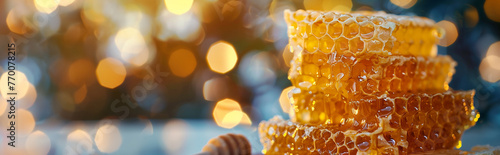 Close-up of glistening honeycomb. Natural food and beekeeping concept. Organic farming and healthy food concept. Banner with copy space for food blogs, and natural sweetener advertising.