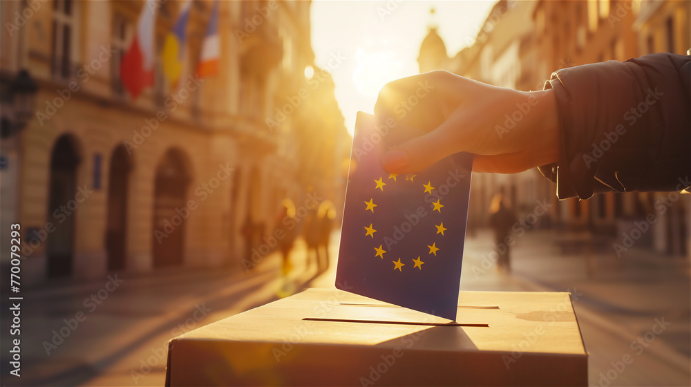 Election in European Union - voting at the ballot box. A hand putting an vote in the ballot box situated on the street.