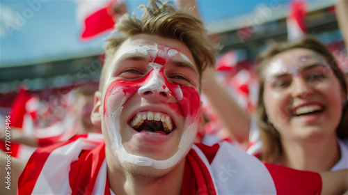 Obraz na płótnie A cheerful fan of the national team with a cheering crowd in the background. w salonie